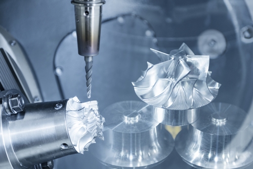 532020997 A five-axis CNC machine cutting an aerospace turbine part