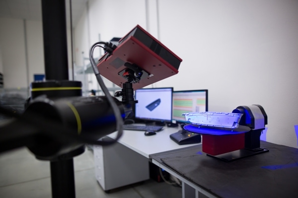 744213262 Engineering 3D measurements for plastic moldings with computer screens on a desk